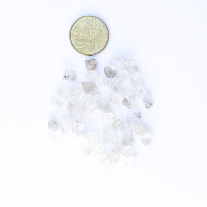 Close‑up of Herkimer Diamond rough gemstones highlighting their glass‑like clarity and sharp natural edges.
