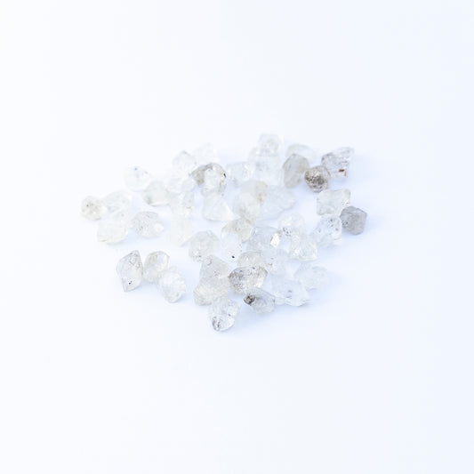 Herkimer Diamond undrilled rough crystals arranged in a group, showcasing natural clarity and bright reflective sparkle.