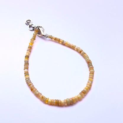 Opal bracelet with smooth beads showing natural iridescence and shine.