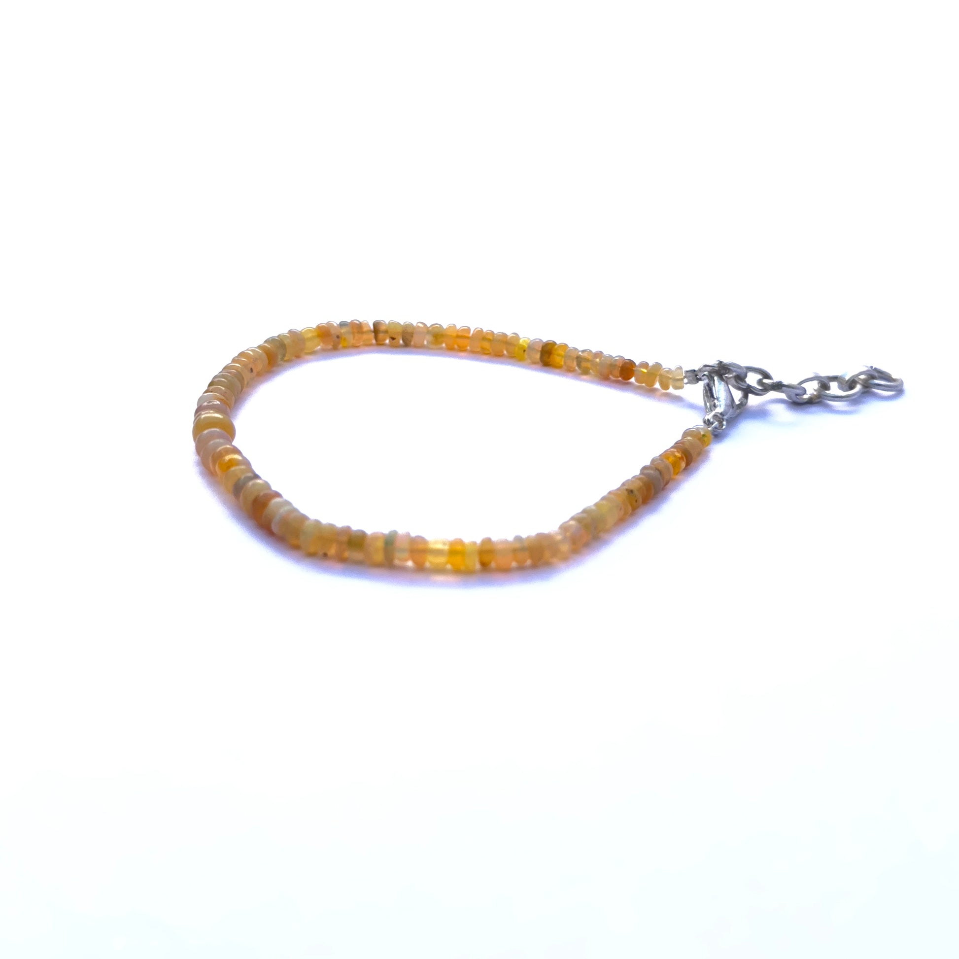 Natural gemstone beads in pastel opals, styled into a sleek adjustable bracelet.