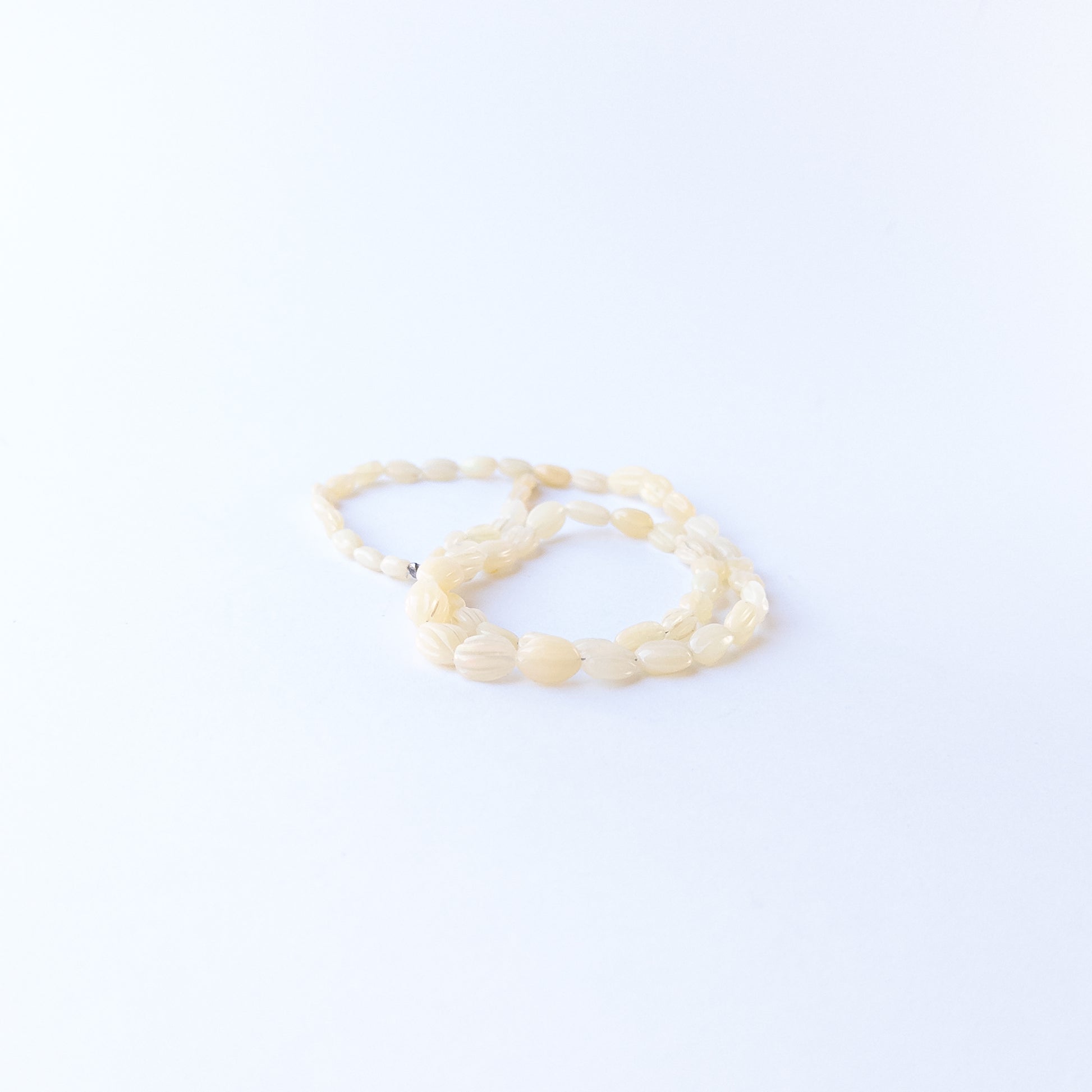 Ethiopian Opal carved oval beads displaying natural colour play and high‑quality craftsmanship.