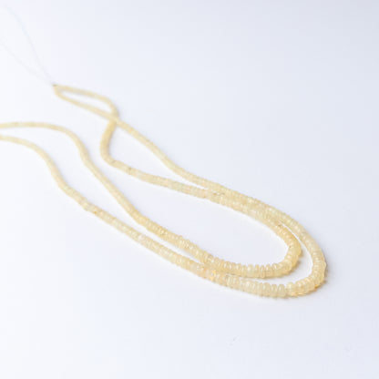 High‑quality Ethiopian Opal rondelle beads arranged neatly for artisan jewellery designs.