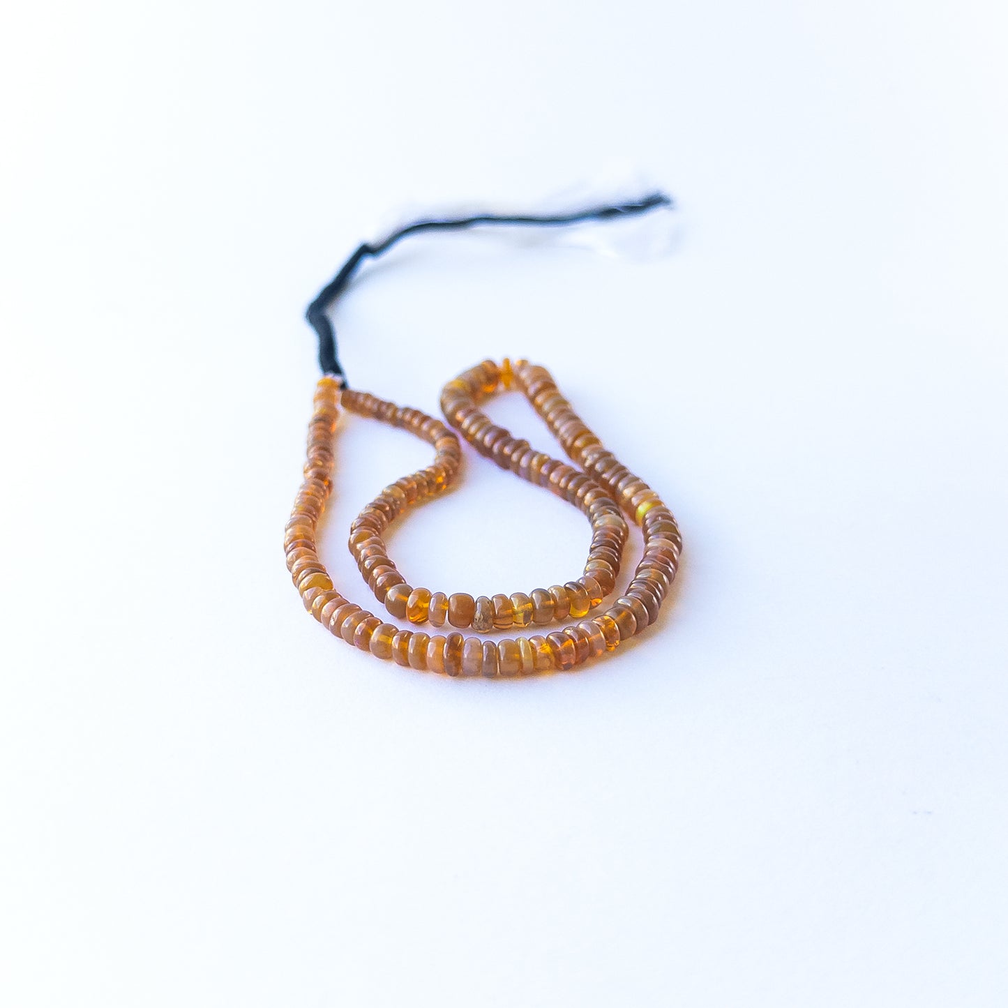 Ethiopian Opal smooth rondelles displaying luminous fire and premium craftsmanship in a 42cm strand.