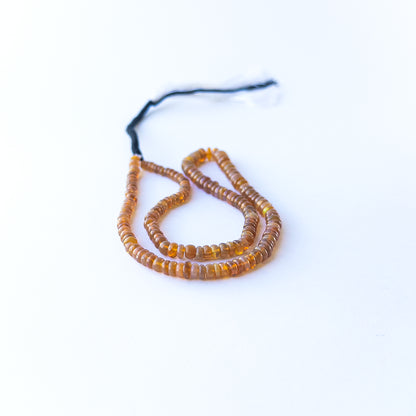 Ethiopian Opal smooth rondelles displaying luminous fire and premium craftsmanship in a 42cm strand.