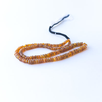 Close‑up of Ethiopian Opal rondelle beads showing their shine, clarity, and natural opalescent glow.
