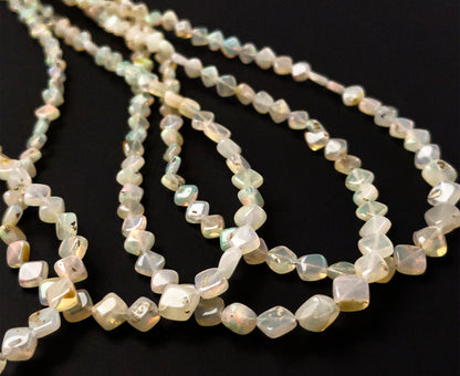 Ethopian Opal rhombus gemstones sized 3.5–6.5mm, arranged in a polished 44cm strand with uniform proportions.