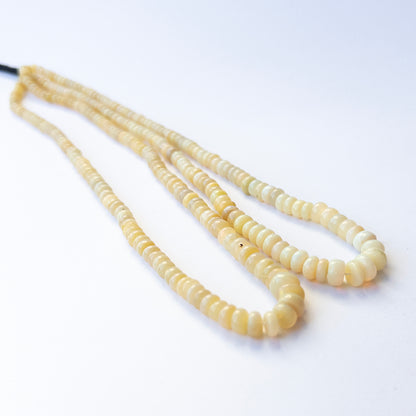Genuine Ethopian Opal gemstone beads in smooth wheel shape, displaying polish, fire, and natural beauty for jewellery crafting.
