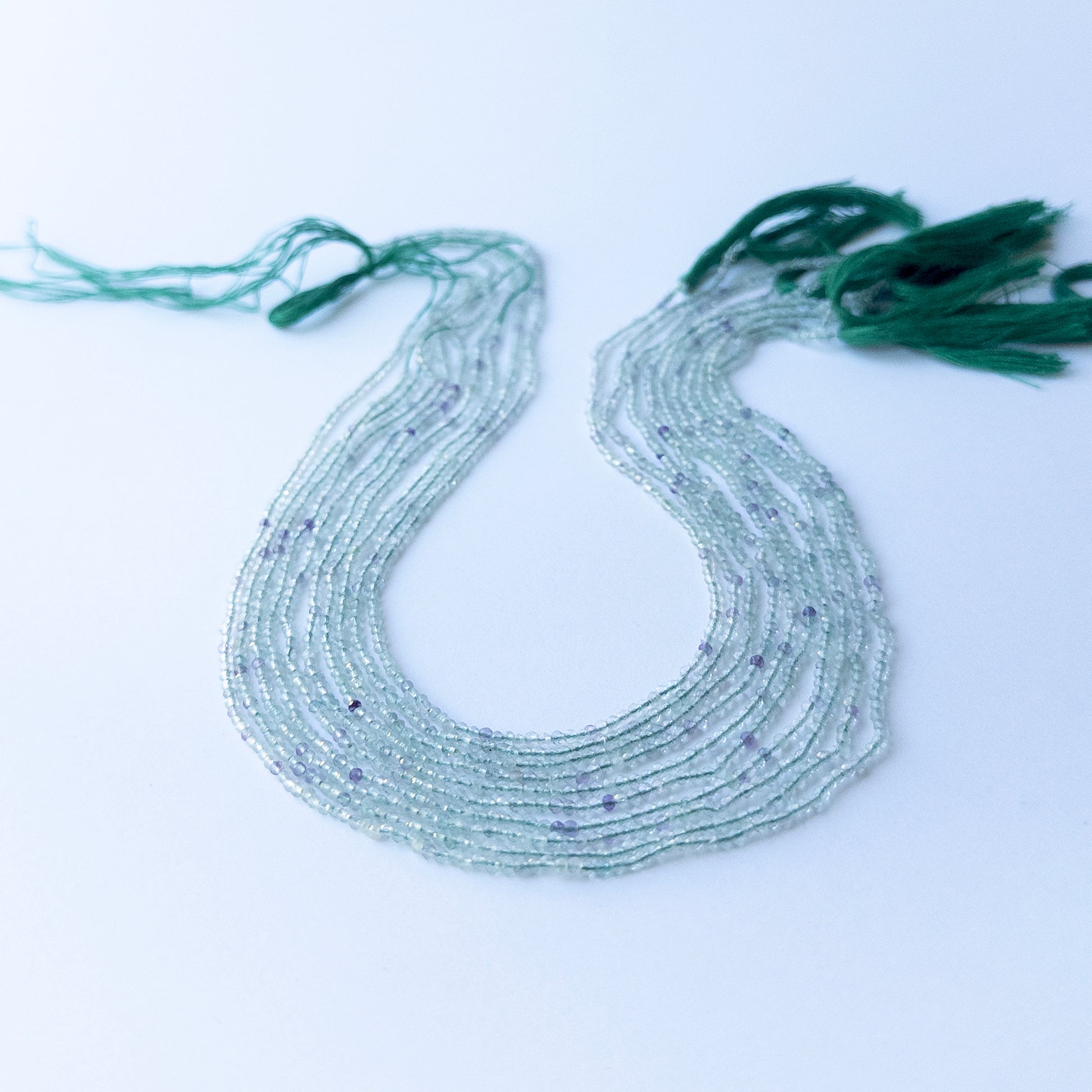 Authentic fluorite stone beads in fine faceted rondelle cuts showing polished sparkle for jewellery design work.