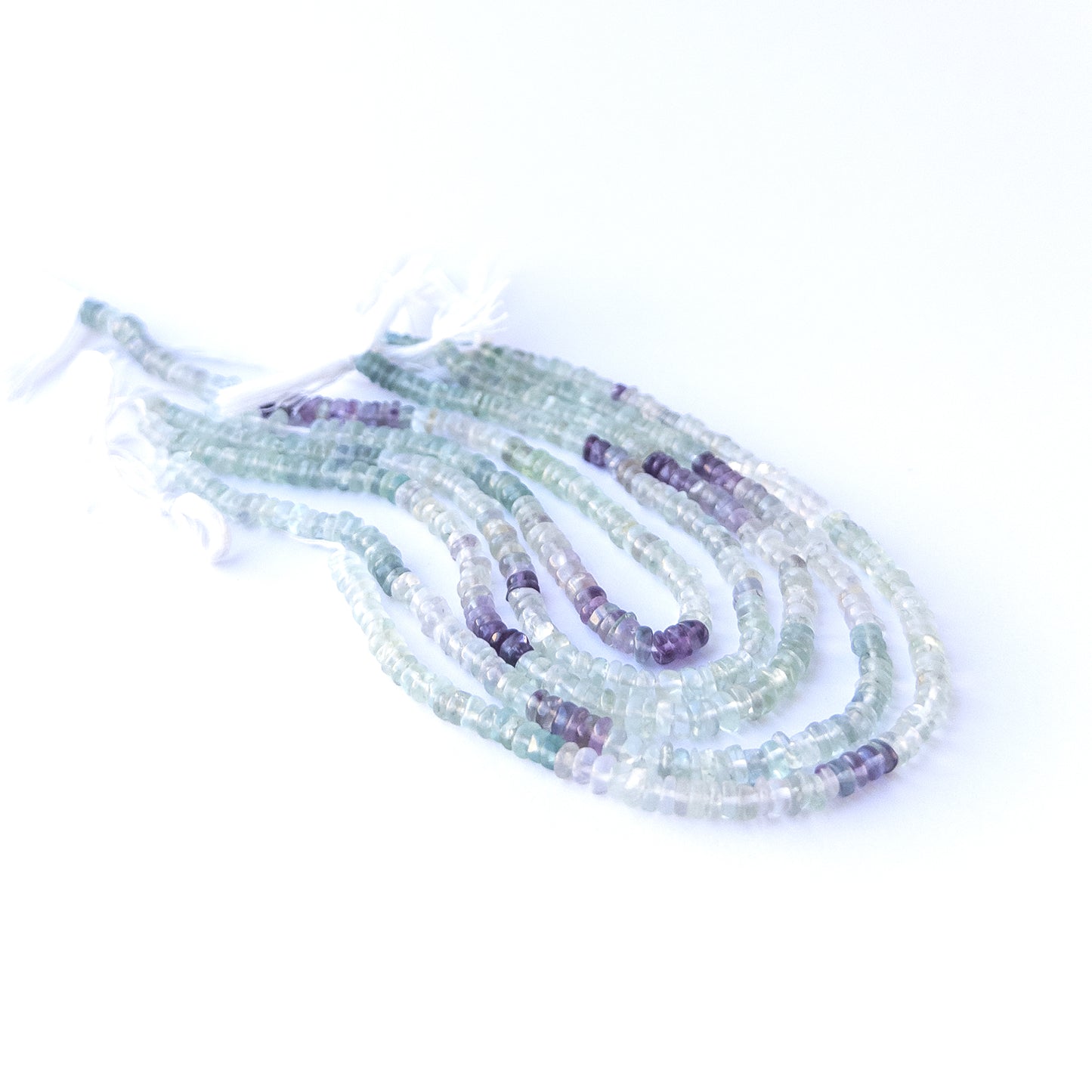 Premium fluorite gemstone beads for DIY jewellery, displaying smooth wheel cuts and multicolour patterns.