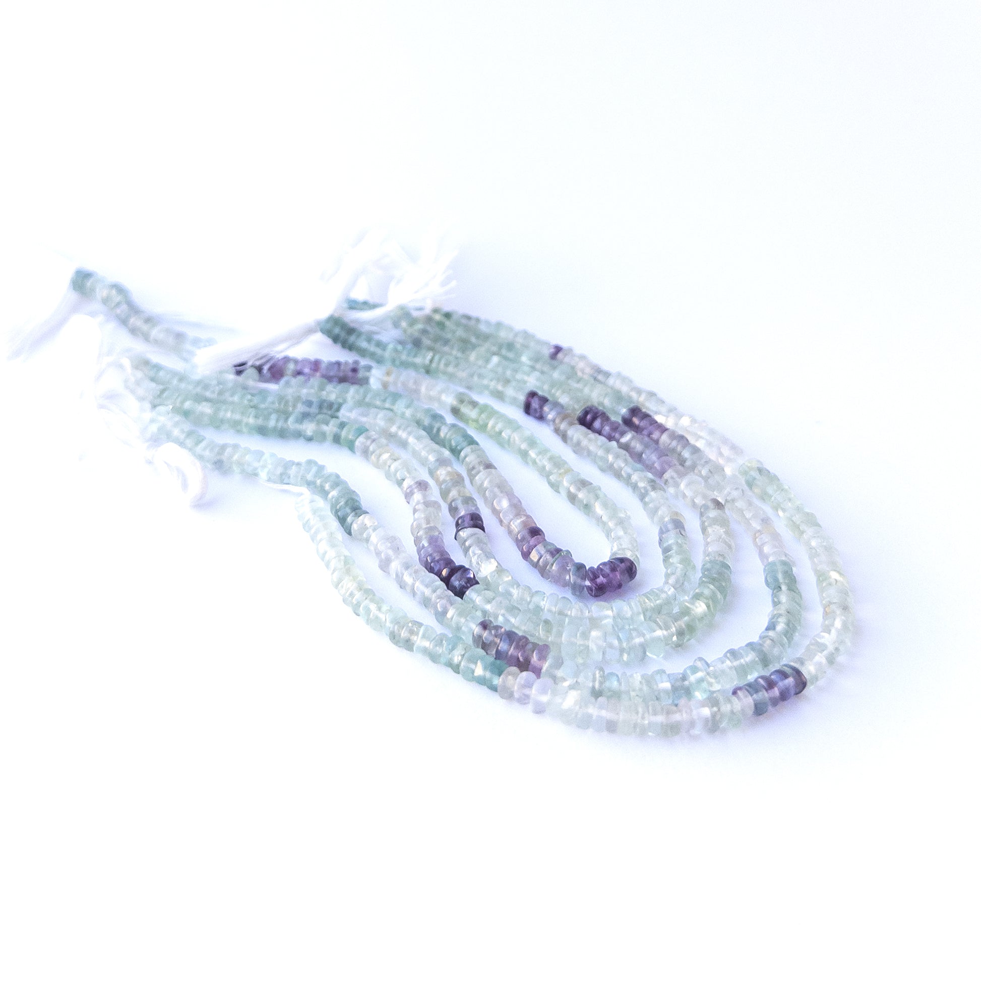 Premium fluorite gemstone beads for DIY jewellery, displaying smooth wheel cuts and multicolour patterns.
