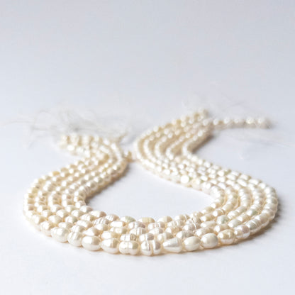 Close‑up of genuine Freshwater Baroque Pearl stone beads with polished surfaces and unique texture.