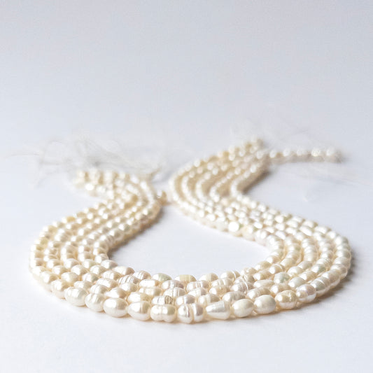 Close‑up of genuine Freshwater Baroque Pearl stone beads with polished surfaces and unique texture.