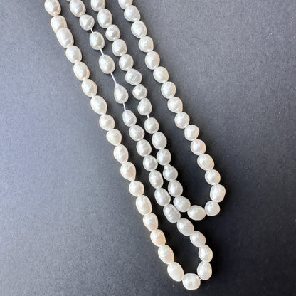 Delicate strands of freshwater pearl beads, showcasing their smooth design.
