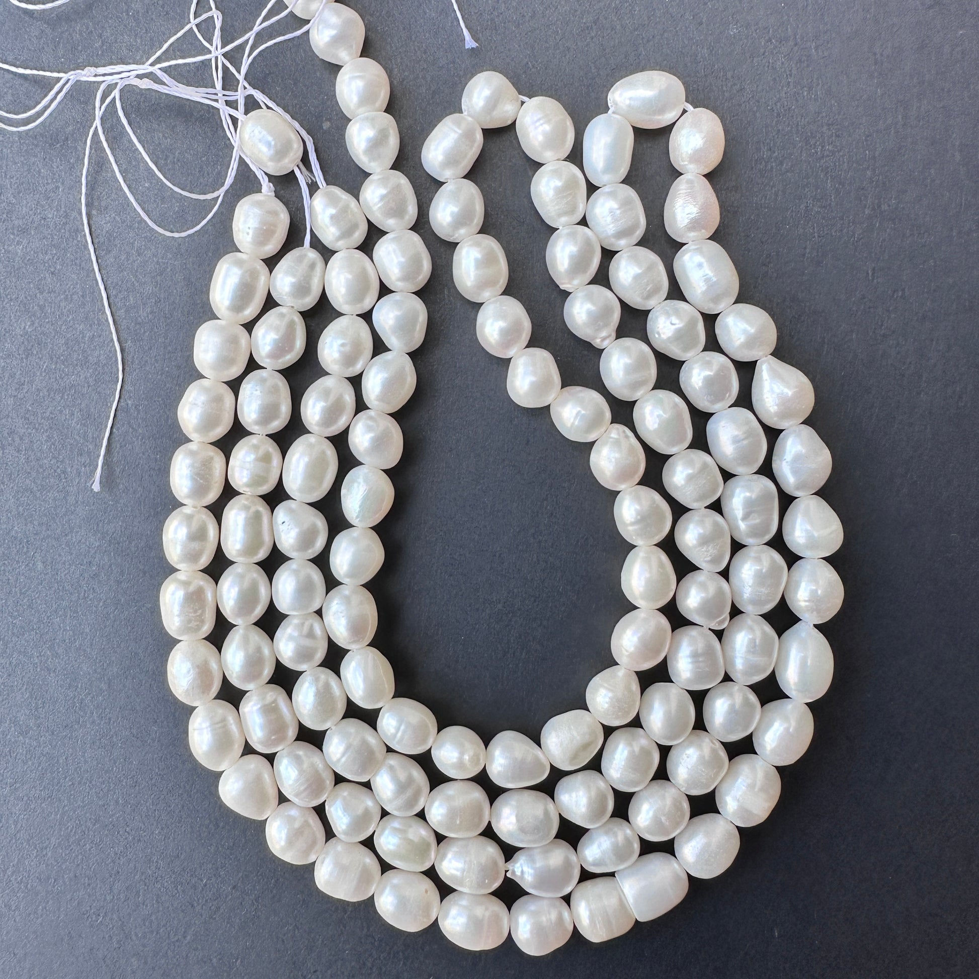 Smooth pearl beads arranged on a 41cm strand featuring 56 natural freshwater pearls for elegant jewellery making.