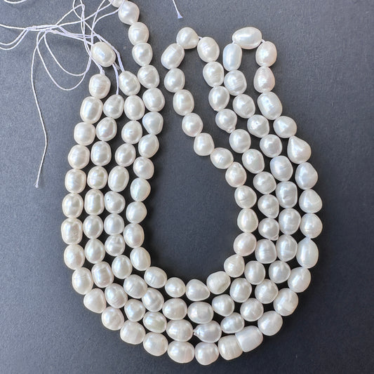 Smooth pearl beads arranged on a 41cm strand featuring 56 natural freshwater pearls for elegant jewellery making.