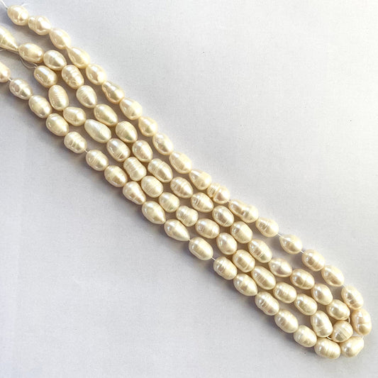 Close-up of Baroque freshwater pearls on a 40cm strand, displaying soft white tones and organic shapes.
