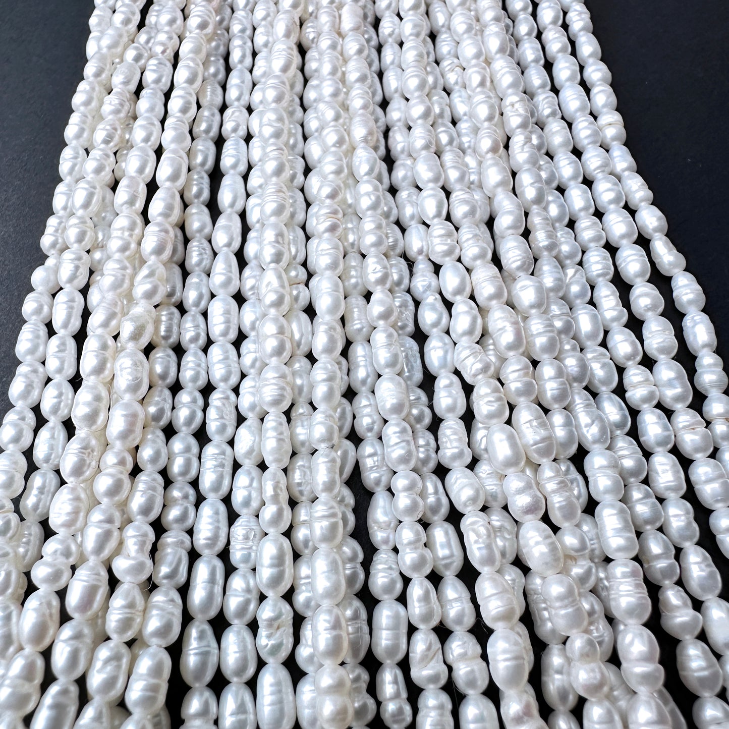 Natural pearls in baroque rice shape, 3.1-3.3mm size, ideal for elegant DIY jewellery designs.