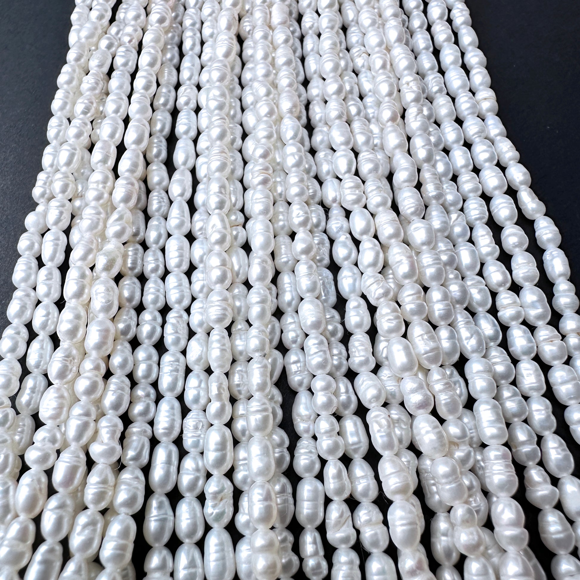 Natural pearls in baroque rice shape, 3.1-3.3mm size, ideal for elegant DIY jewellery designs.