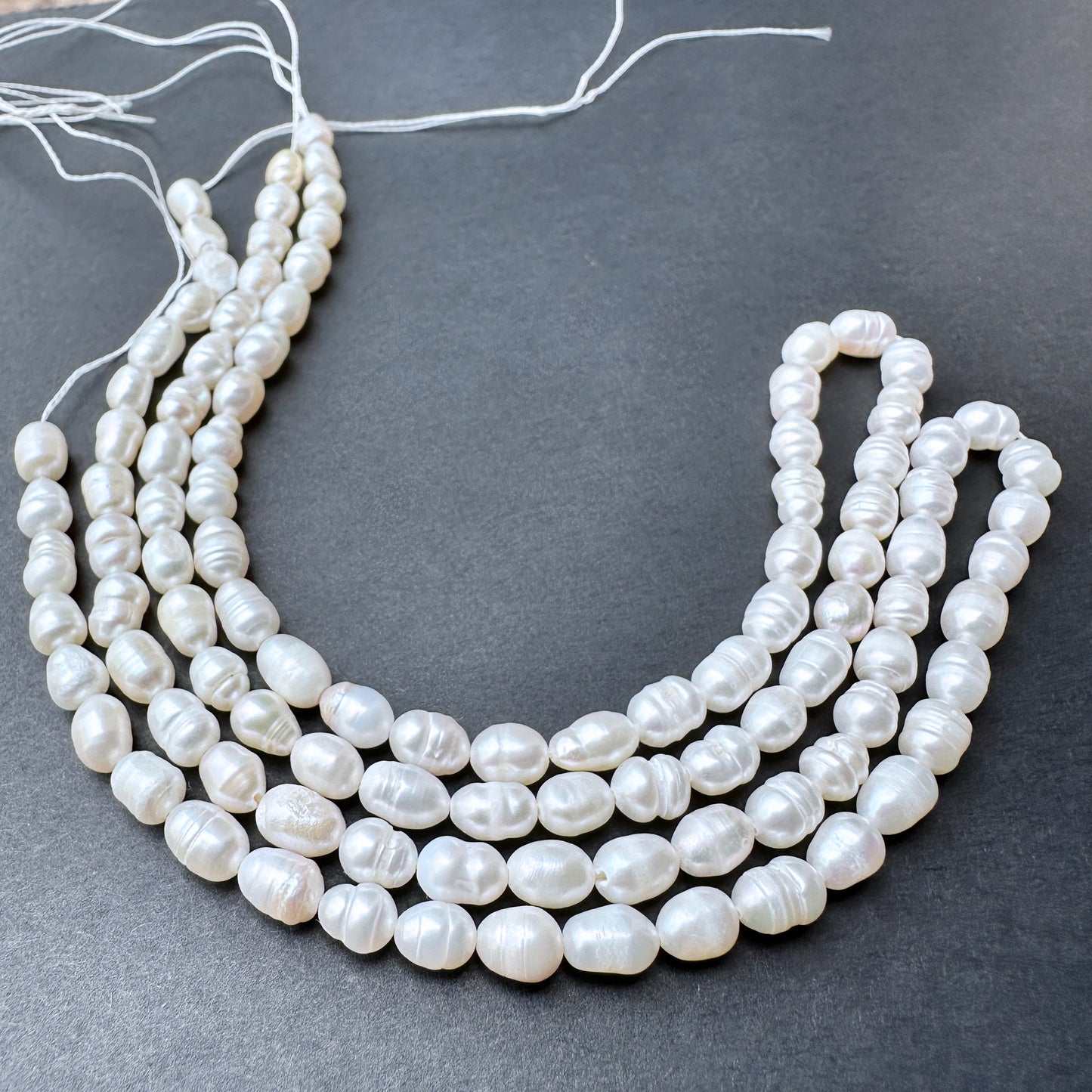 Natural pearls in baroque rice shape, 5.5-7mm length ‚àö√≥ 4.8-5.0mm breadth, ideal for elegant DIY jewellery designs.