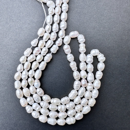 Freshwater Pearls in baroque rice shapes with soft lustre arranged on a 32cm strand for jewellery making.
