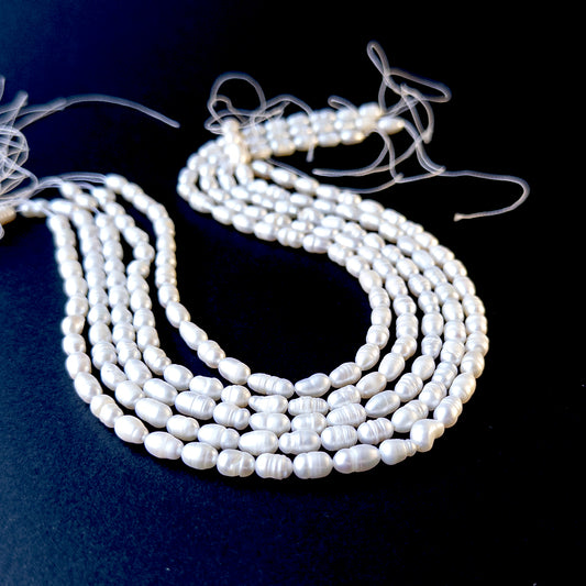 Freshwater baroque rice‑shaped pearls in 7.5–8.5mm x 5mm size on a 33cm strand, showcasing natural lustre.