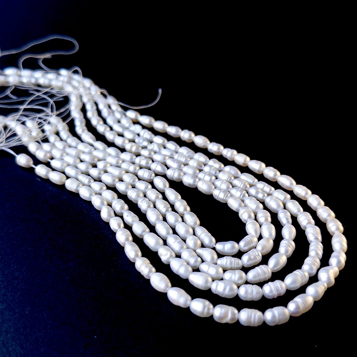 Genuine pearls with soft white tones and natural texture, featuring baroque rice shapes for DIY jewellery making.