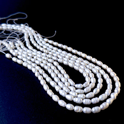 Genuine pearls with soft white tones and natural texture, featuring baroque rice shapes for DIY jewellery making.