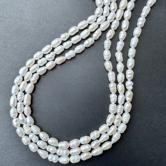Freshwater Pearls in baroque rice shapes with soft lustre arranged on a 34cm strand for jewellery making.