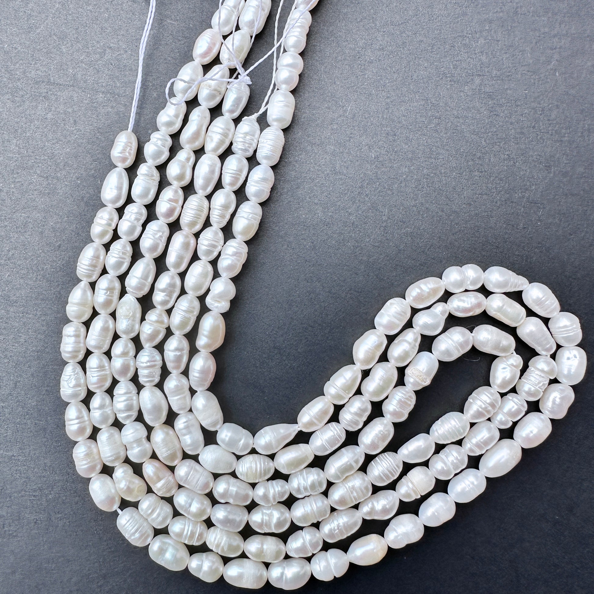 Delicate strands of Freshwater Pearls, showcasing their natural beauty.