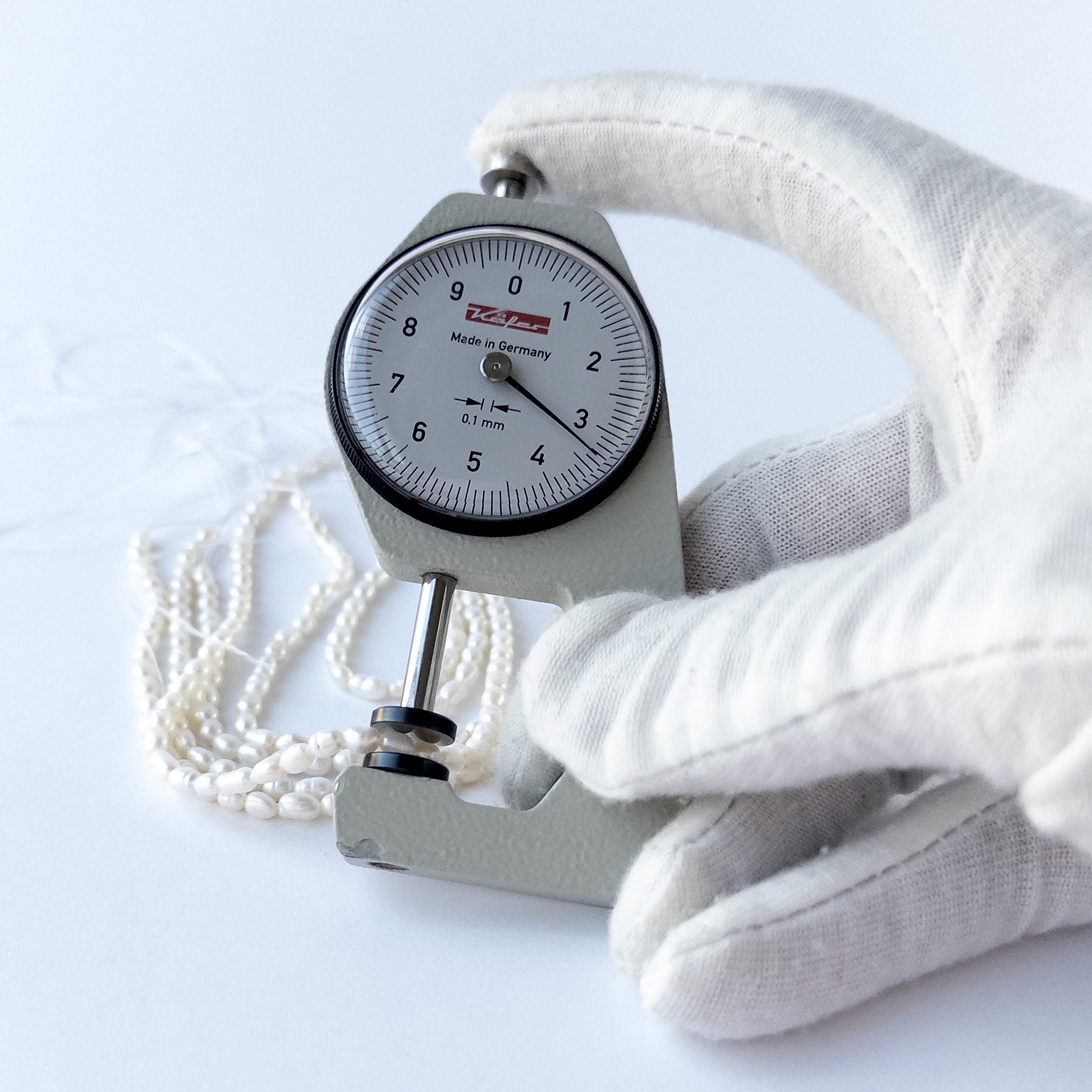 A dial gauge measures the Freshwater Pearls fancy oval 3.2–3.4mm gemstone.