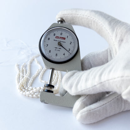 A dial gauge measures the Freshwater Pearls fancy oval 3.2–3.4mm gemstone.