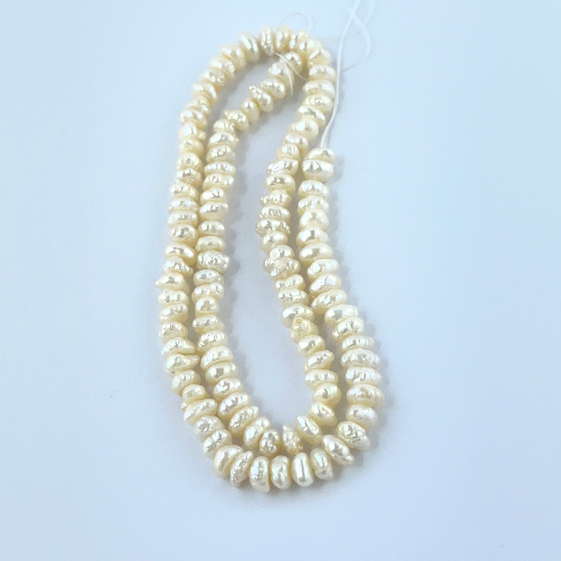 Freshwater Pearl 5.5–6mm beads with radiant shine and irregular baroque form.