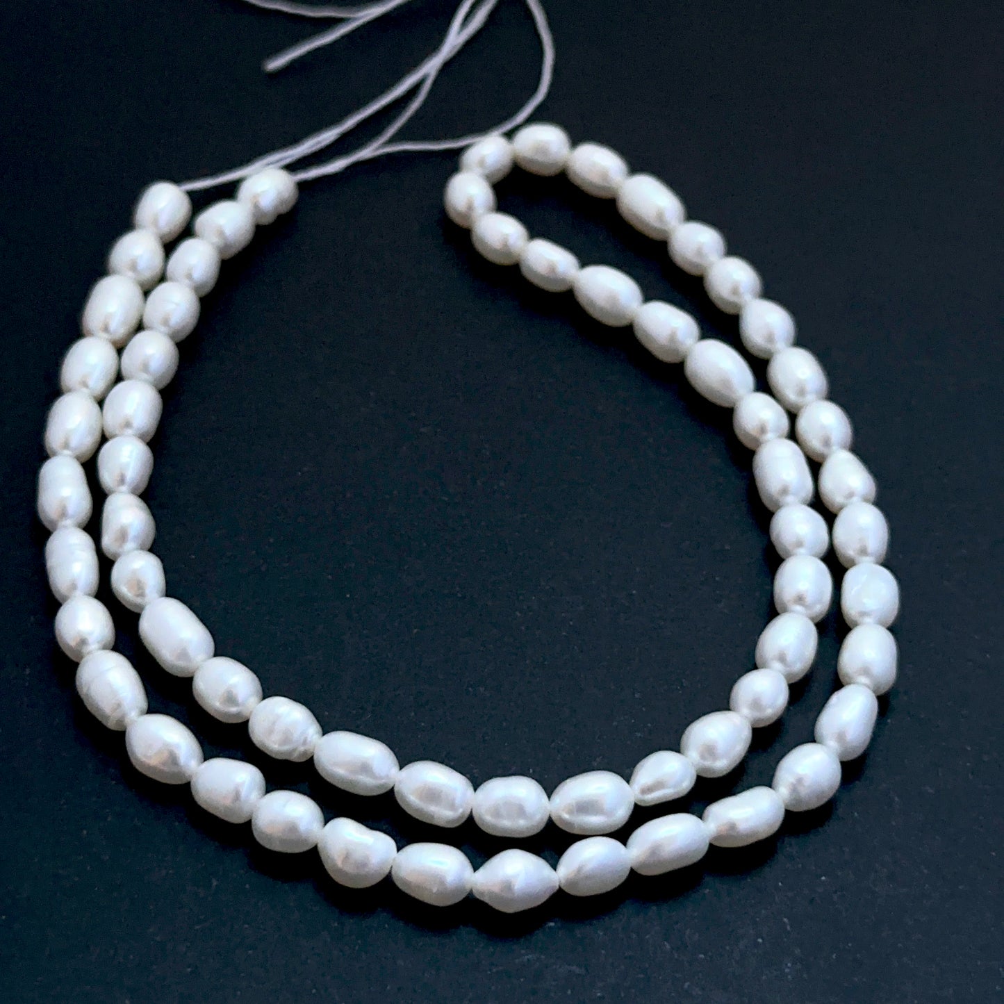 Freshwater oval pearl beads with soft lustre arranged on a 38cm strand for handmade jewellery components.