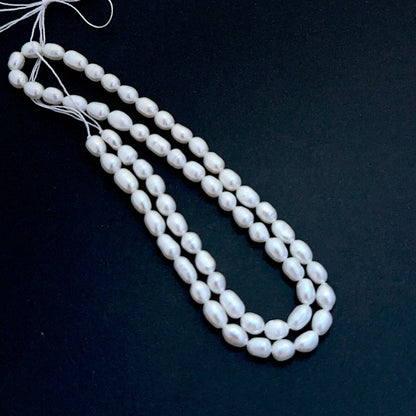 Detailed view of premium freshwater pearl beads showing consistent 4.5mm sizing and elegant lustre.