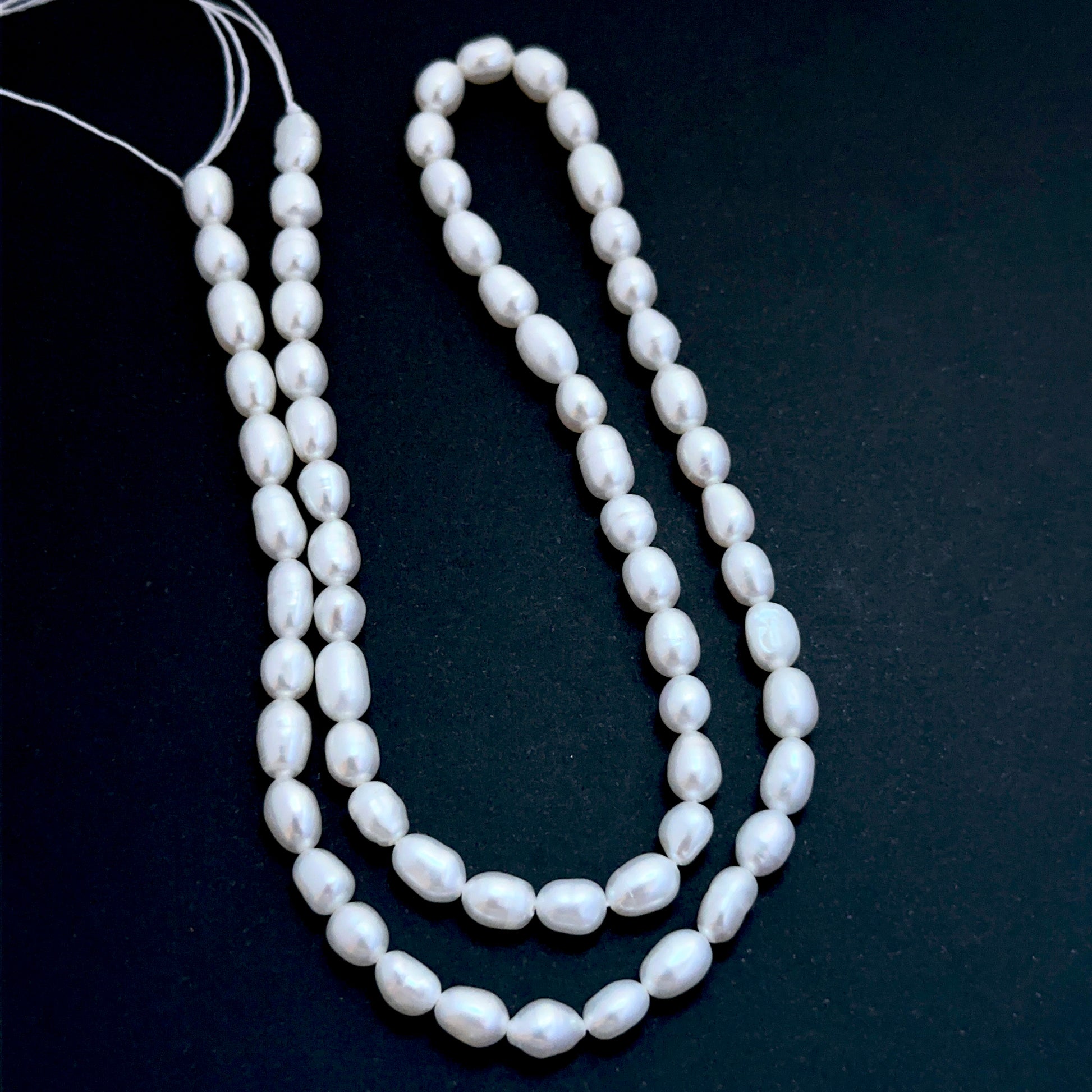 Delicate strands of Freshwater Pearls beads, showcasing their smooth design.