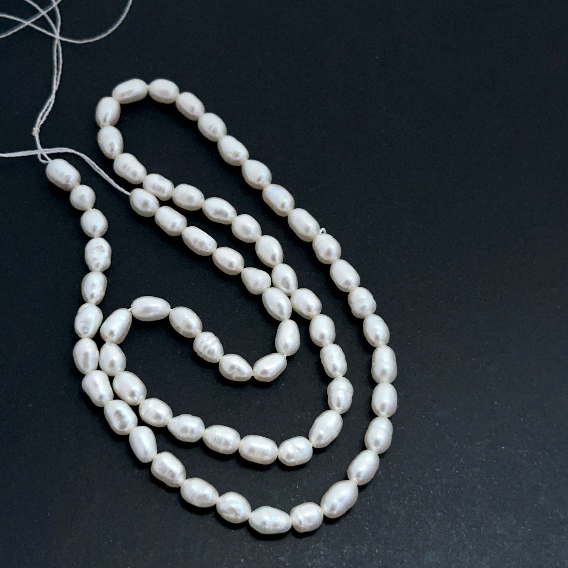 Freshwater oval fancy pearls aligned on a strand highlighting organic shapes, creamy tones and high‑quality finish.