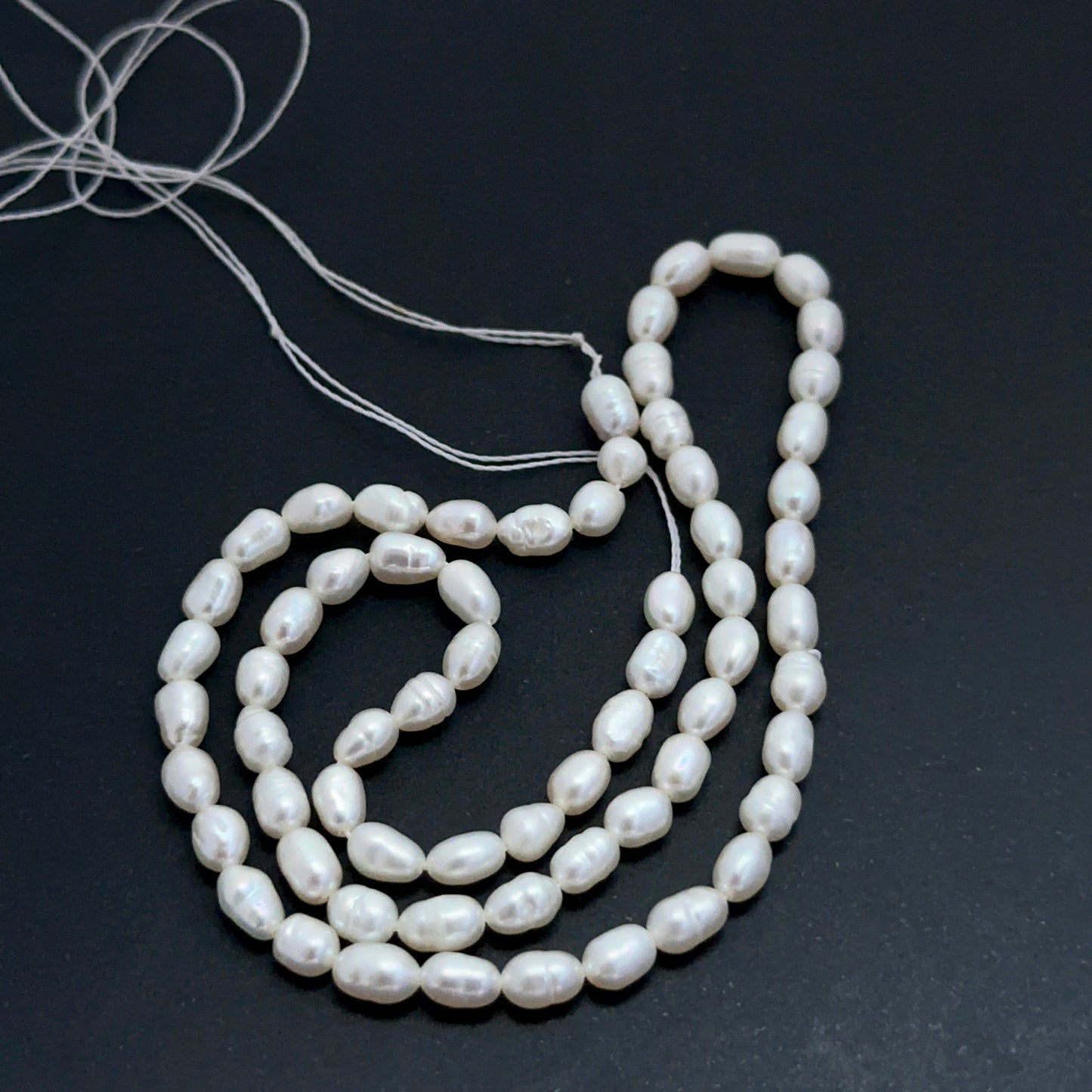 Detailed view of premium freshwater pearl beads showing consistent sizing, elegant lustre and refined oval fancy form.