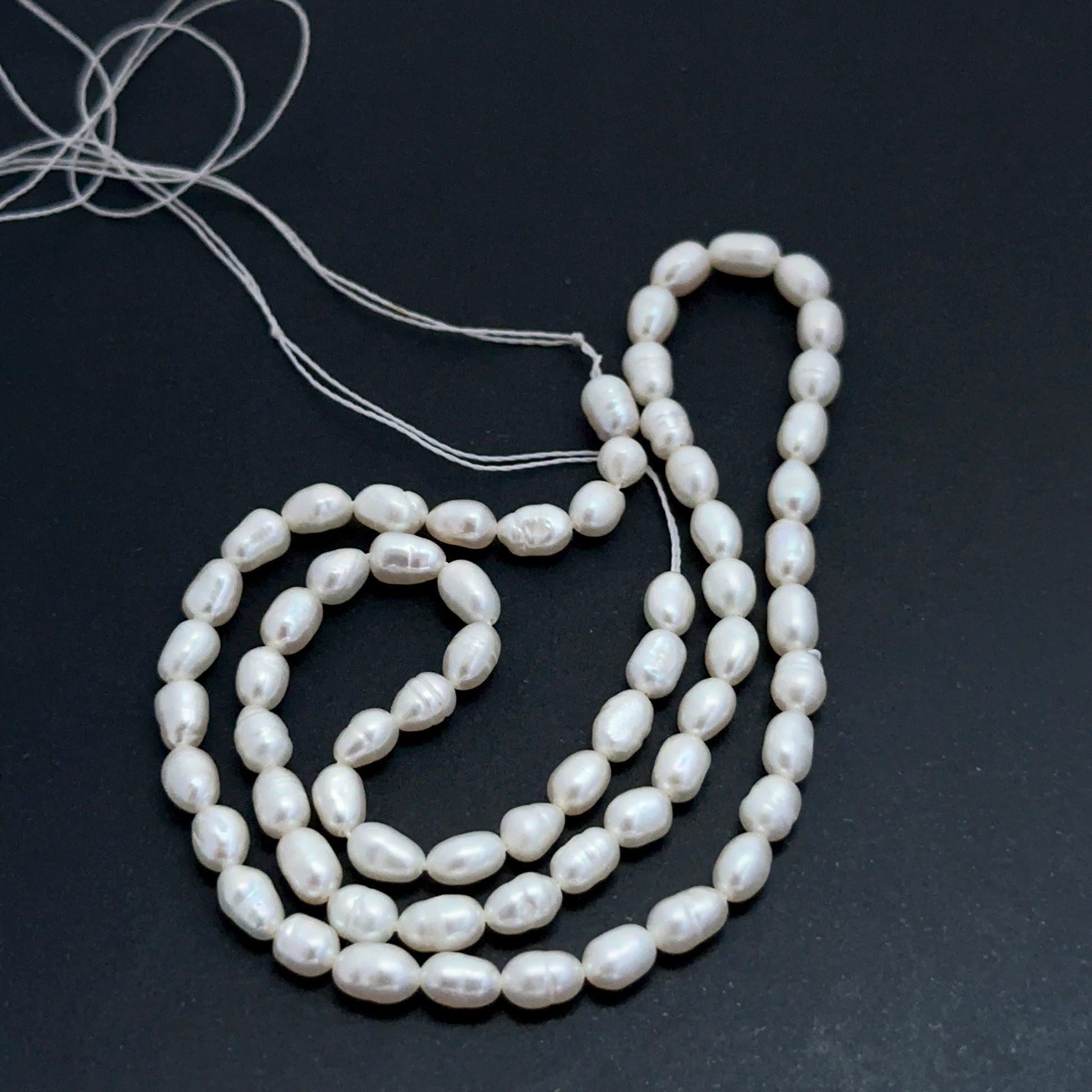 Detailed view of premium freshwater pearl beads showing consistent sizing, elegant lustre and refined oval fancy form.