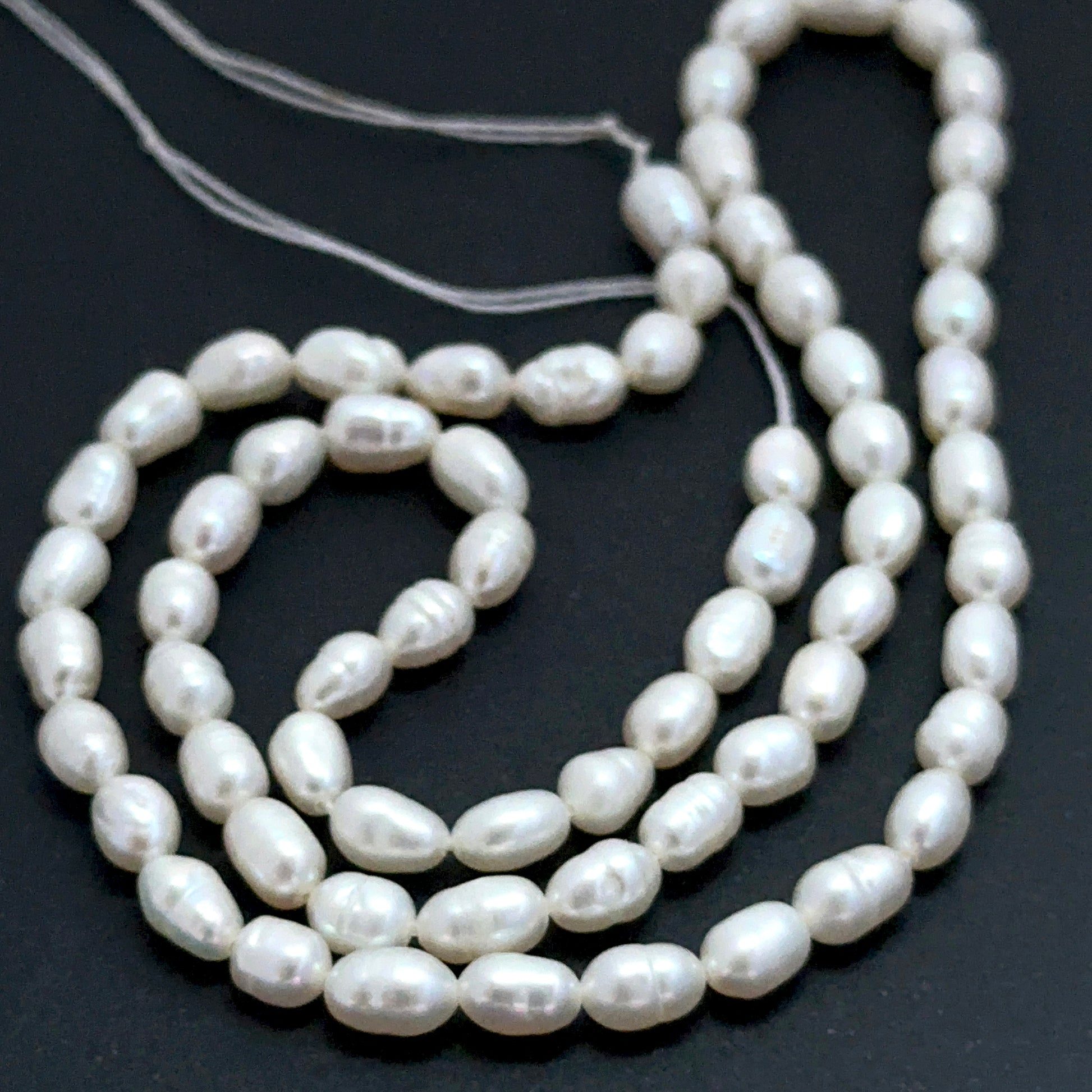 Close‑up of 3.7–3.9mm freshwater pearl beads showing smooth surfaces and natural shine ideal for natural gemstone beads for DIY jewellery.