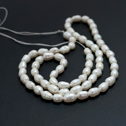 Freshwater oval fancy pearl beads with soft lustre arranged on a 35cm strand for handmade jewellery components.