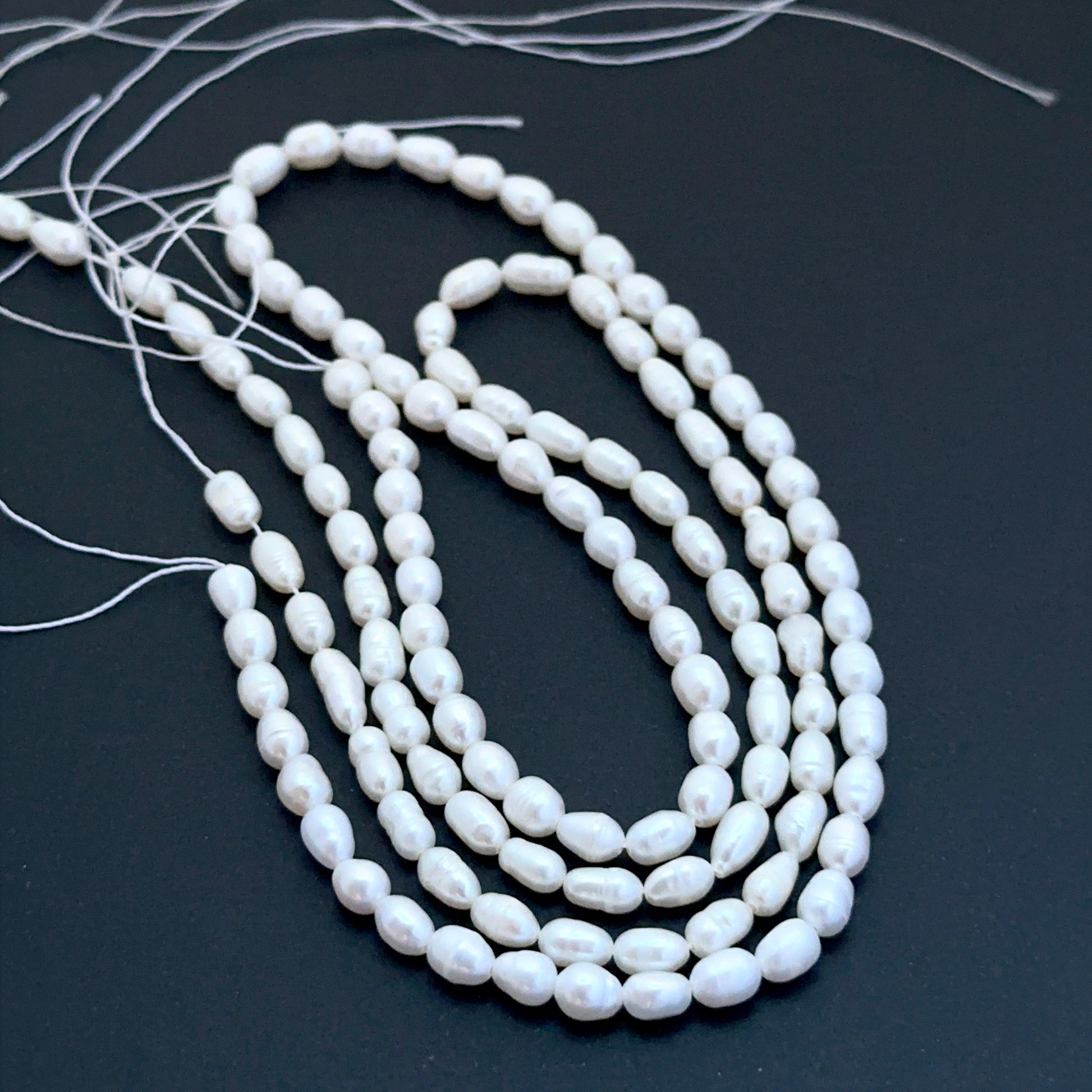 Freshwater oval fancy pearls aligned on a strand highlighting organic shapes, creamy tones and elegant lustre.