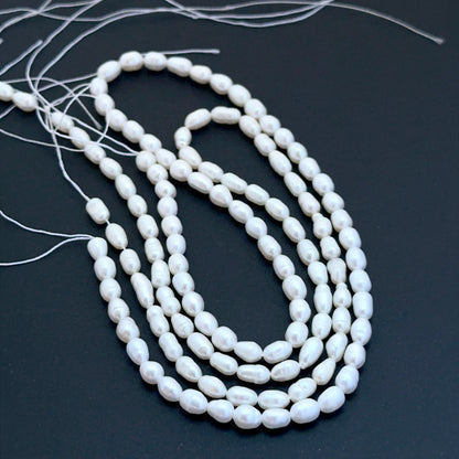 Freshwater oval fancy pearls aligned on a strand highlighting organic shapes, creamy tones and elegant lustre.