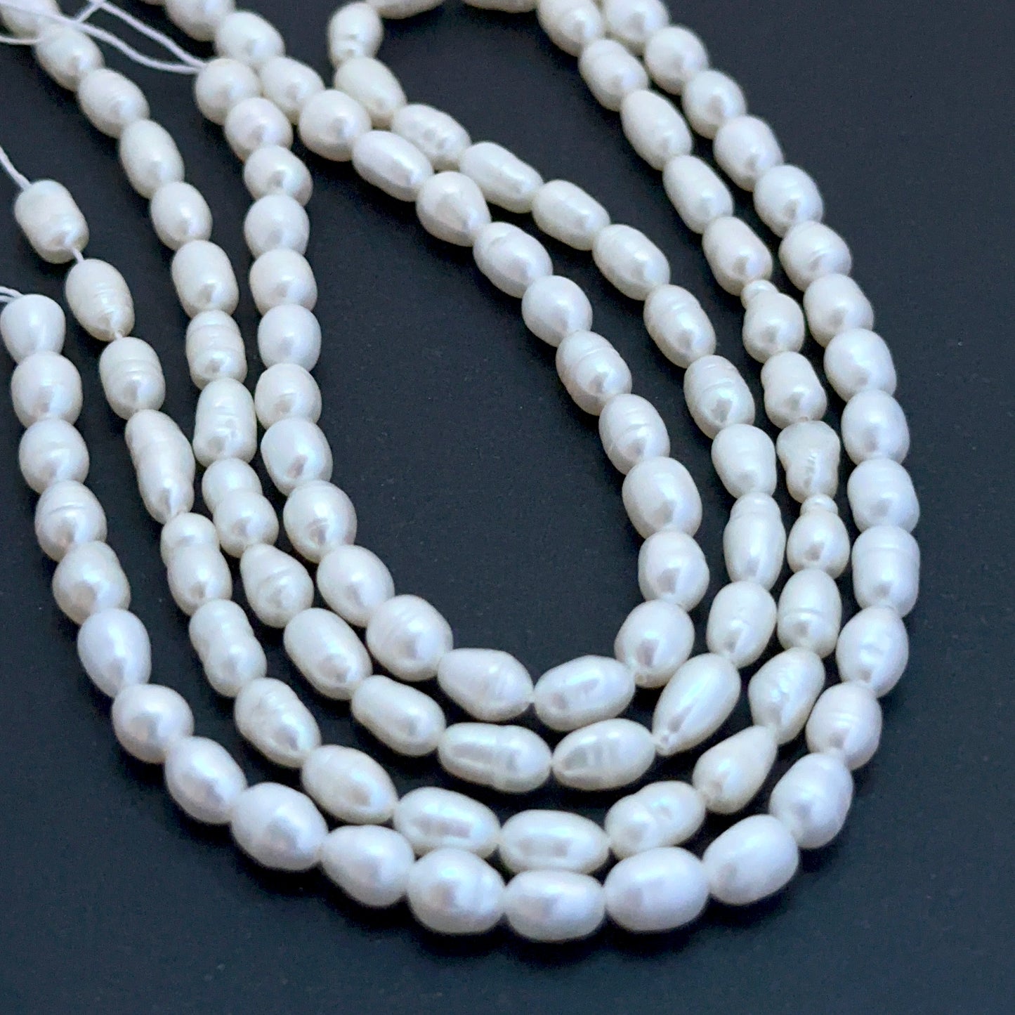 Freshwater oval fancy pearl beads with soft lustre arranged on a 35cm strand for handmade jewellery components.