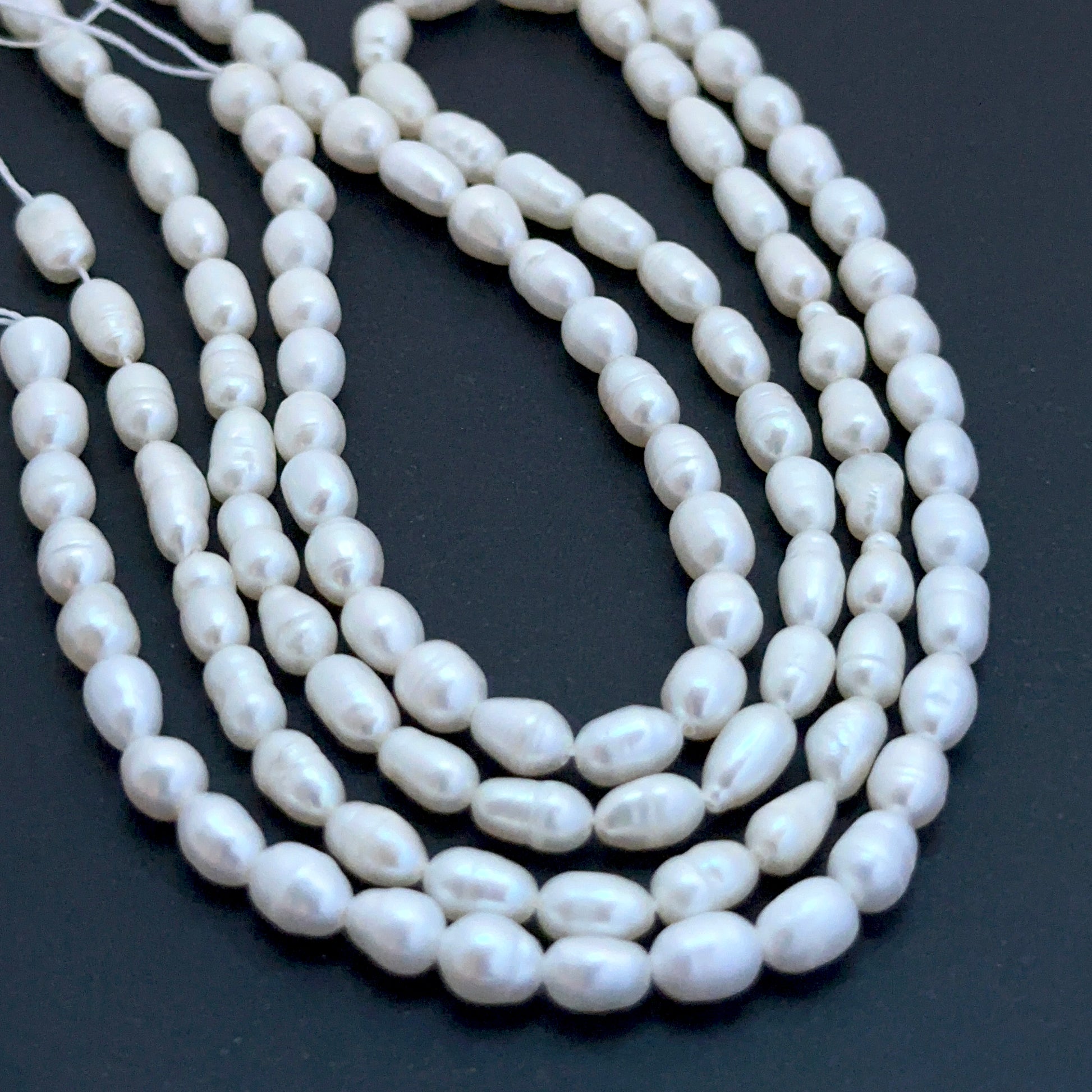 Freshwater oval fancy pearl beads with soft lustre arranged on a 35cm strand for handmade jewellery components.