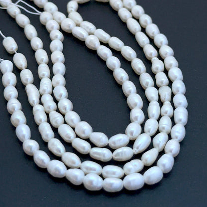 Freshwater oval fancy pearl beads with soft lustre arranged on a 35cm strand for handmade jewellery components.