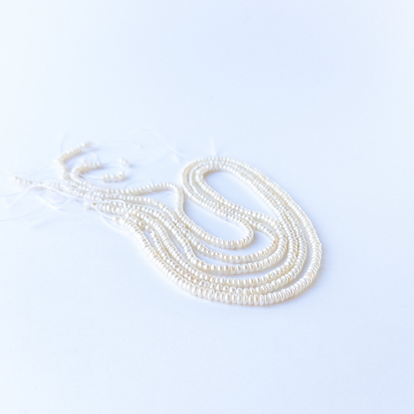 Handmade jewellery components featuring Freshwater Pearl rondelles with polished finish and classic pearl glow.