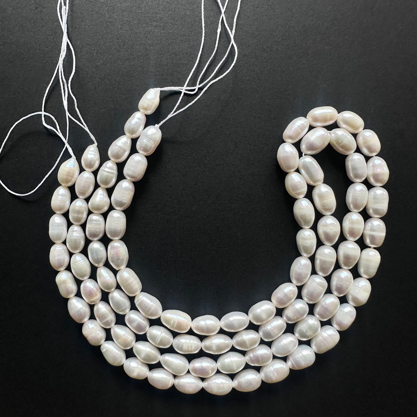 Natural gemstone beads featuring Freshwater Pearls with a creamy white sheen and smooth surface.