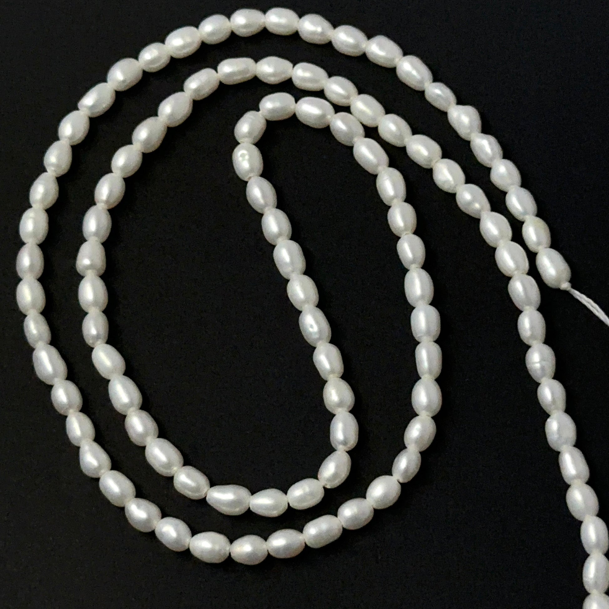 Freshwater Pearl smooth rice beads in soft white tones, showcasing 3mm stone beads ideal for DIY jewellery.