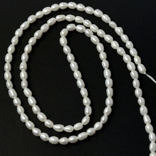 Freshwater Pearl smooth rice beads in soft white tones, showcasing 3mm stone beads ideal for DIY jewellery.