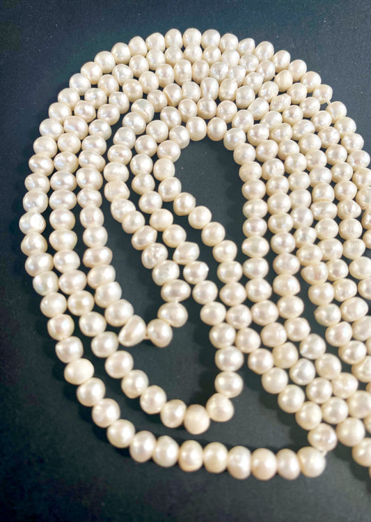 Close-up of 4.5–5mm smooth rondelle Freshwater Pearls with radiant white tones arranged on a 37cm strand.